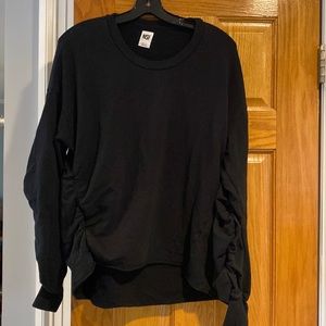 NSF cozy black sweatshirt with rouched sleeves.